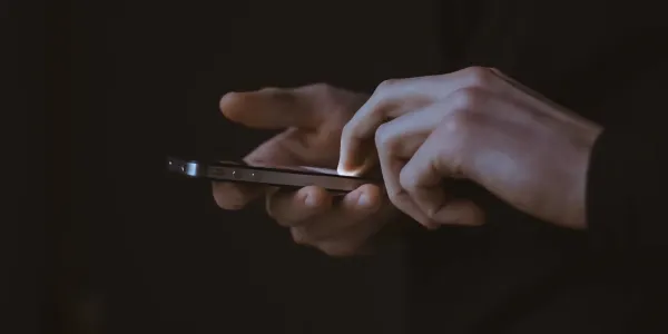 Fingers tapping on iPhone screen